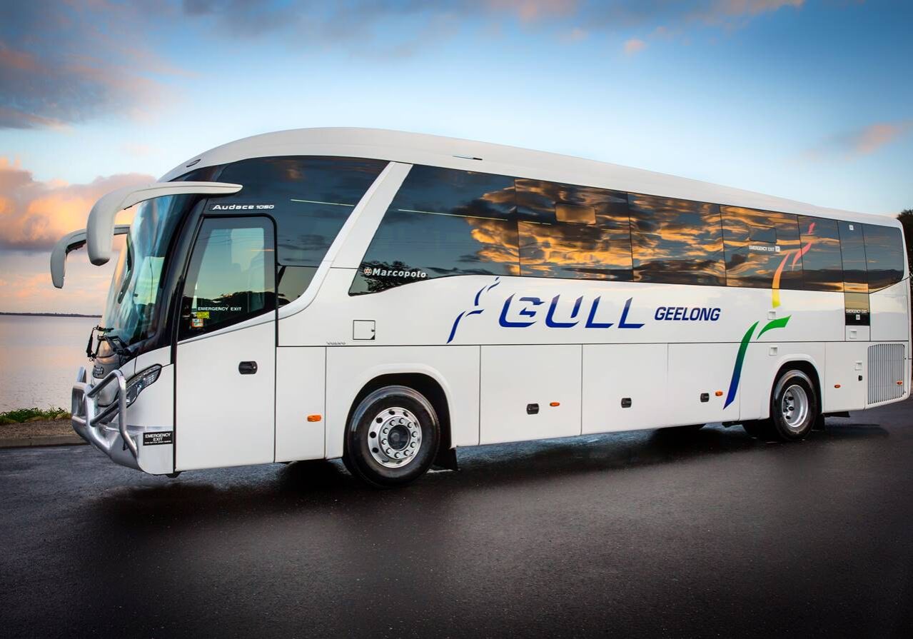 A Gull coach waiting by the Geelong waterfront at sunset